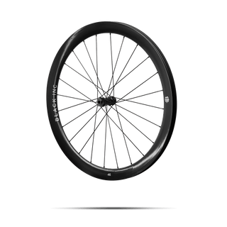 Quarter-turned side view of Black Inc FORTY SIX gravel rear wheel that appears to be floating against a transparent background.