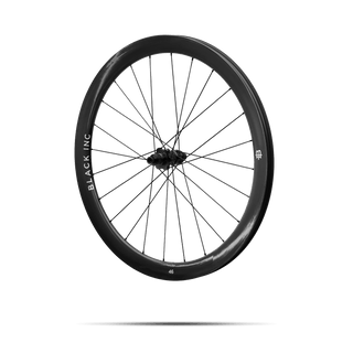 Quarter-turned side view of Black Inc FORTY SIX gravel front wheel that appears to be floating against a transparent background.